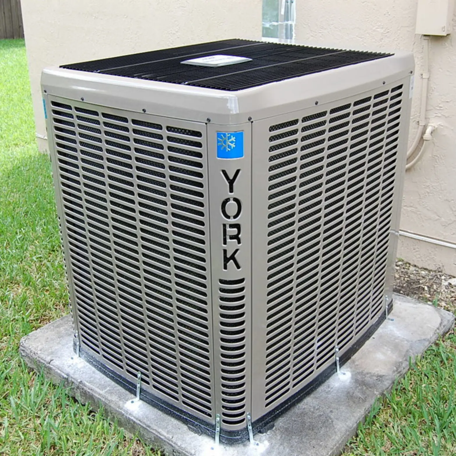 A York brand outdoor air conditioning unit installed on a concrete base.