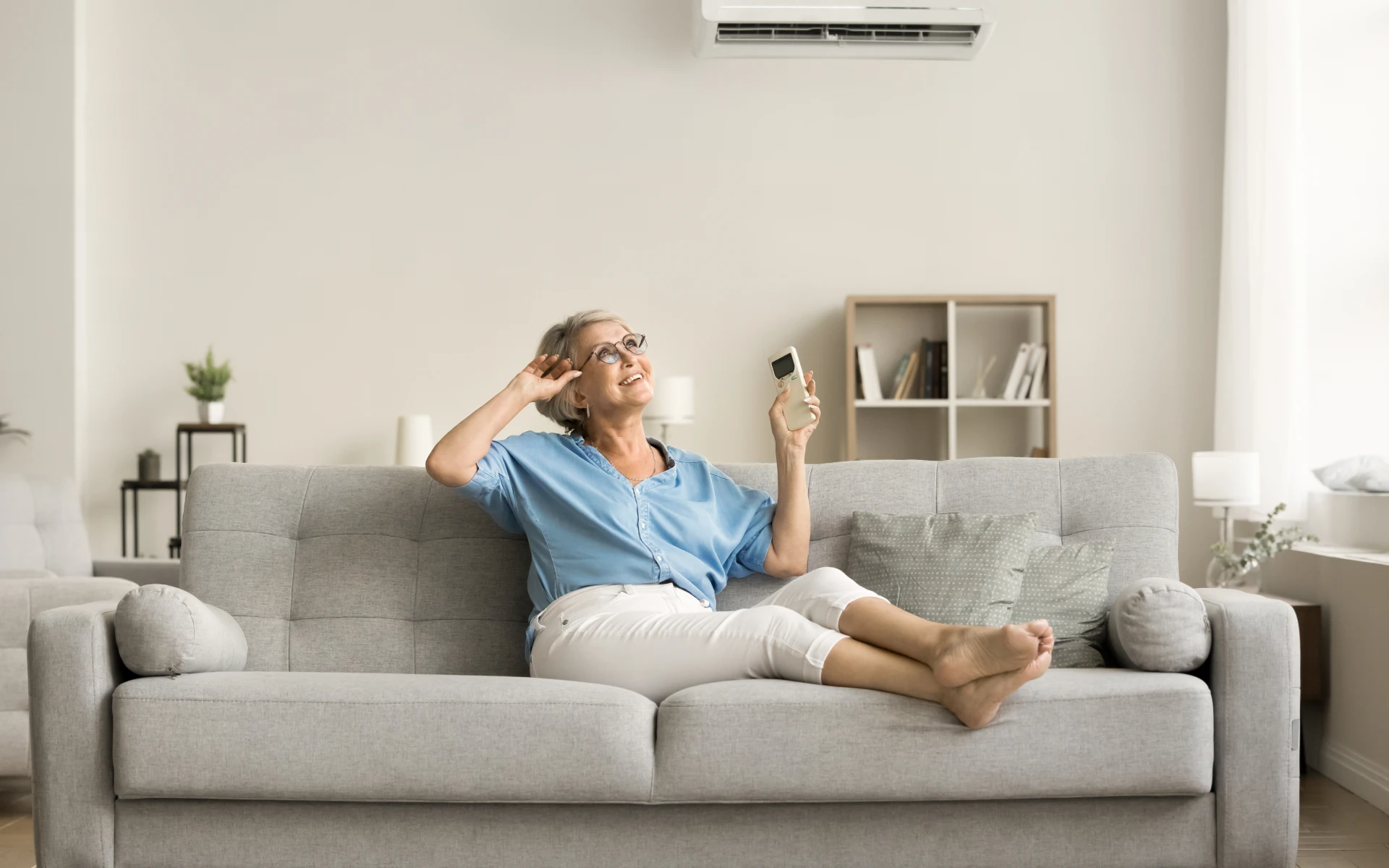 Woman relaxing on couch with remote control.